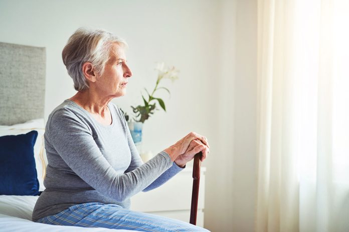 Dec2023_GettyImages_1315315110_SeatedSeniorWomanBed